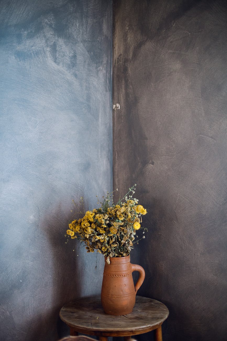 wild flowers in pitcher in dark room